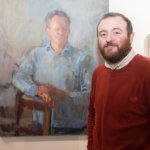 Daniel Shadbolt standing by one of his paintings