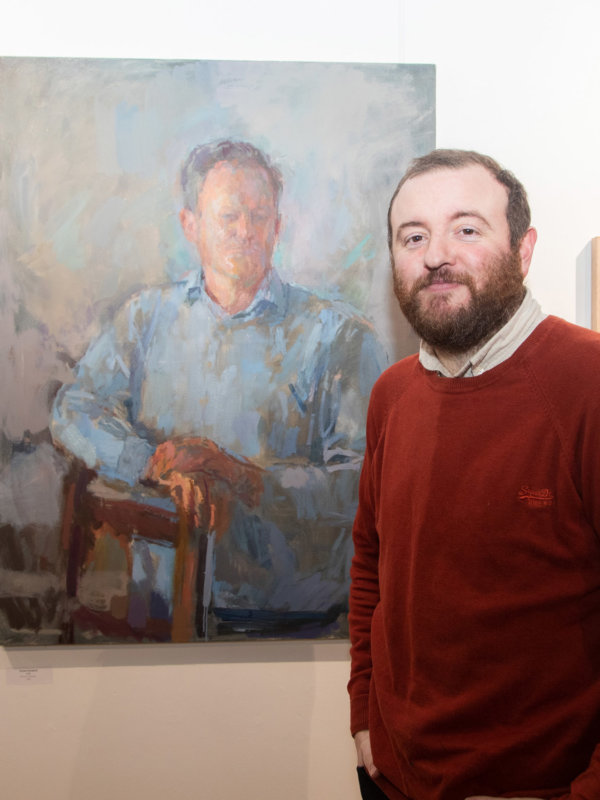 Daniel Shadbolt standing by one of his paintings