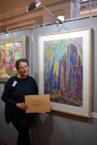 Maria Kaleta with her pastel drawing City of London Metamorphosis at The Chelsea Art Society’s annual Open Art Exhibition in Chelsea Town Hall in 2022.