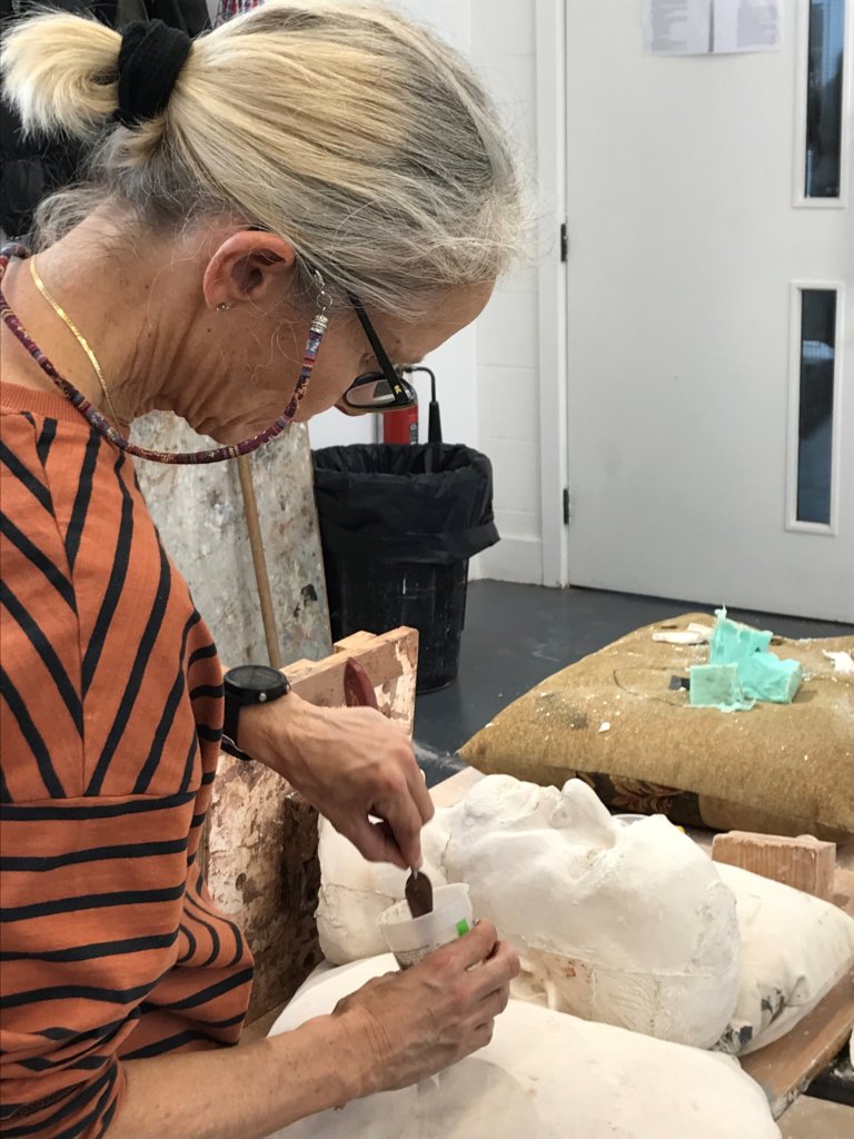 Heatherleys Sculpture Diploma student working on a plaster cast of a portrait head.