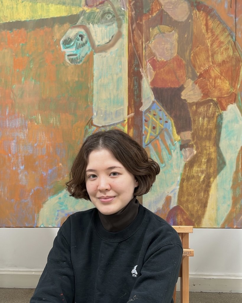 Artist and Heatherleys Portrait Diploma graduate Kayoon Anderson in front of her painting Merry go round