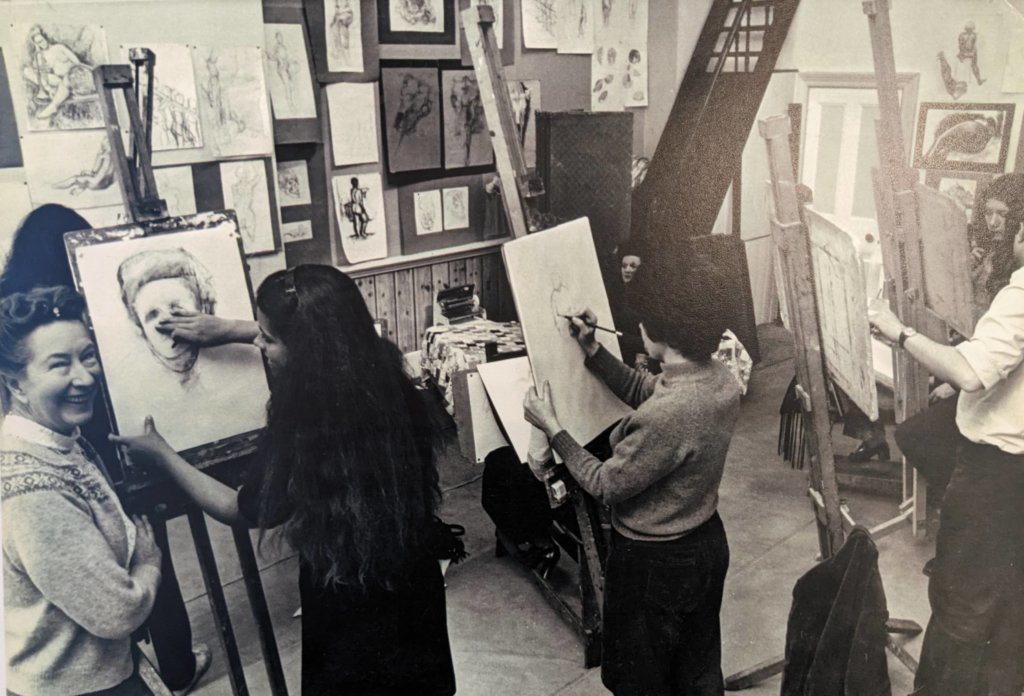 Photo of Helen Wilson in the studio with her students at Heatherley-Wilson School of Arts and Crafts. Image sourced from the Heatherleys Archive.