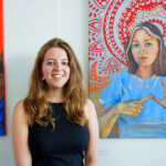 Natasha Lumley winner of the 2nd year World’s End Studio Prize stands in front of her paintings and the Heatherley Graduates’ Exhibition Private View 2023.