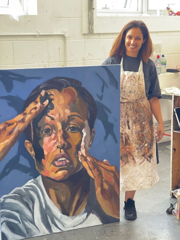 Annis Booker with her painting The Struggle with Colour in the Heatherleys studio 2023