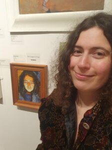 Natalia Glinoer with her Self Portrait at the RBA exhibition at the Mall galleries
